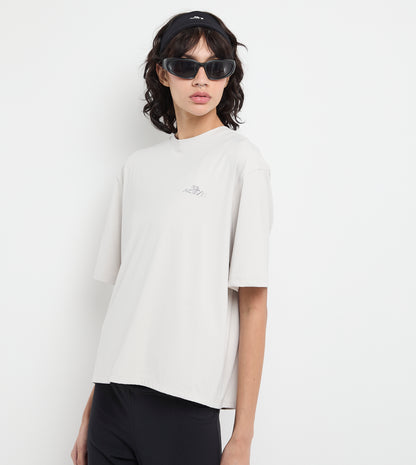 Person wearing a white t-shirt and black pants on a plain background