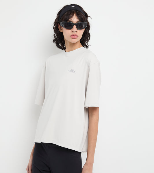 Person wearing a white t-shirt and black pants on a plain background